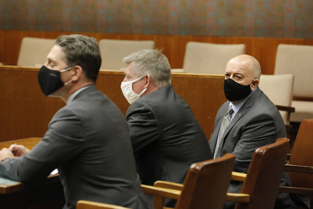 Former Sonoma County Sheriff's Deputy Charles Blount, right, sits with his attorneys during a pretrial hearing for charges of involuntary manslaughter at the Hall of Justice in Santa Rosa, California, on Wednesday, Dec. 8, 2021. (Beth Schlanker/The Press Democrat)