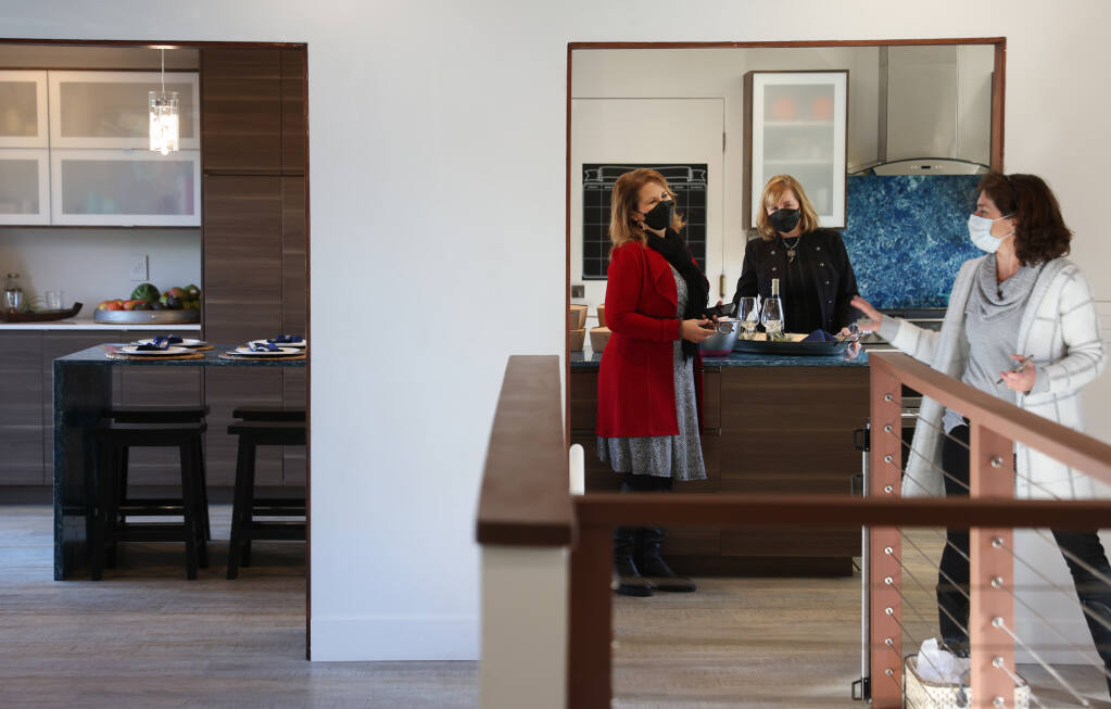 Compass real estate agents Sheela Hodes, from left, Tammra Borrall and Katie Kelly talk while holding an open house for a home listing on Caber Drive in Santa Rosa on Tuesday, Jan. 25, 2022.  (Christopher Chung / The Press Democrat)