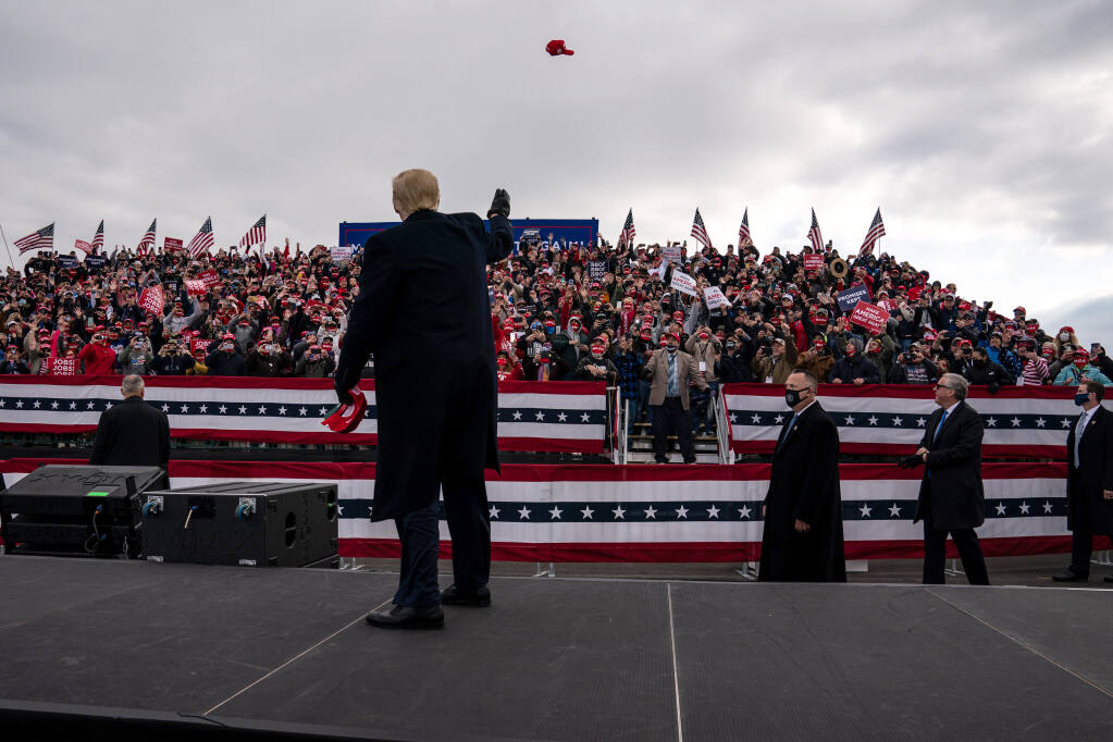 President Donald Trump throws hats into the crowd during a campaign rally at Reading Regional Airport in Reading, Pa., on Saturday, Oct. 31, 2020. (Anna Moneymaker/The New York Times)