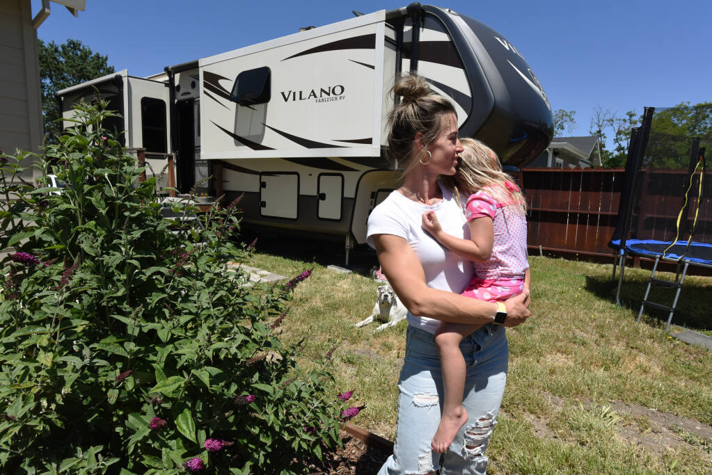 “My dad always says, something will always work out, and I just think you have to have faith,” said Jessica Brown, holding her daughter Rose Brown, 3, where she and her husband are currently renting a 360-square-foot Fifth Wheel RV parked in the driveway of her parent’s home, while the couple continues to search for an affordable home in Santa Rosa, Calif., on Friday, May 19, 2022. (Photo: Erik Castro/for The Press  Democrat)