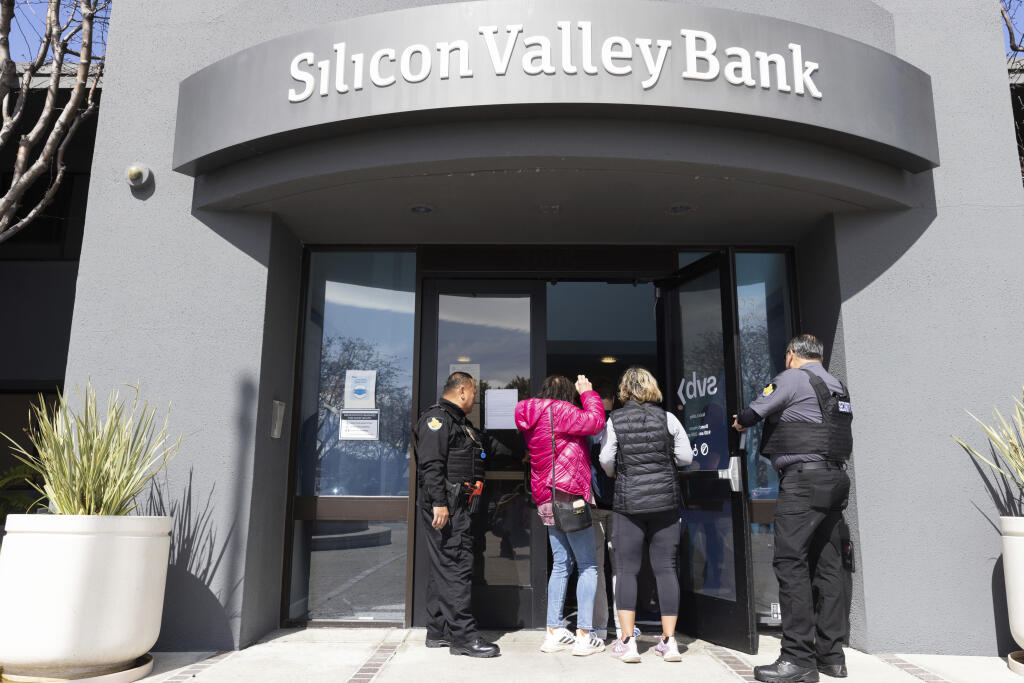 FILE - Security guards let individuals enter the Silicon Valley Bank's headquarters in Santa Clara, Calif., March 13, 2023. While Wall Street struggles to contain the banking crisis after the swift demise of SVB — the nation's 16th largest bank and the biggest to fail since the 2008 financial meltdown — industry experts predict it could become even harder for people of color to secure funding or a financial home that supports their startups. (AP Photo/ Benjamin Fanjoy, File)