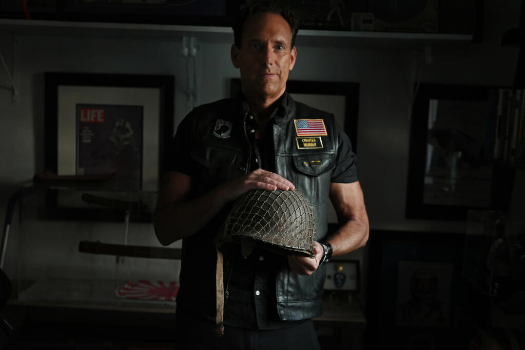 North Bay Spirit Award winner Joe Noriel holding the helmet that his father Ron Noriel wore while serving in the Korean War at his home in Petaluma, Calif., on Friday, Oct. 20, 2022. (Erik Castro / For The Press Democrat)