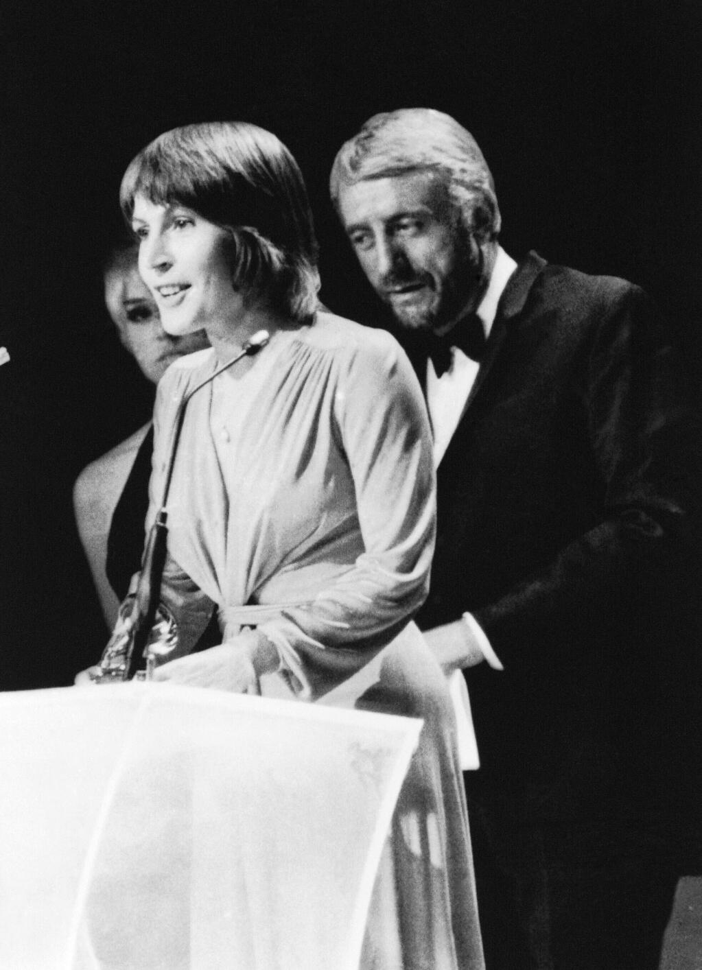 FILE - In this March 3, 1973, file photo, Helen Reddy wins a Grammy Award for the best female song of the year in Nashville, Tenn. Reddy, who gained prominence for her woman's liberation song "I Am Woman," said upon accepting the award, "I'd like to thank God because she made everything possible." Reddy, the Australian-born singer who scored an enduring hit with her feminist anthem “I Am Woman,” has died at 78 in Los Angeles. Reddy’s children announced their mother’s death Tuesday evening, Sept. 29, 2020, saying that while they are heartbroken, they “take comfort in the knowledge that her voice will live on forever.” (AP Photo, File)