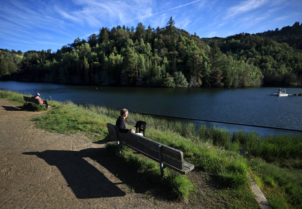 Ted Williams and his dog Charlie enjoy a crisp spring afternoon at nearly full Phoenix Lake, Tuesday, April 19, 2022 at Natalie Coffin Greene Park in Marin County. (Kent Porter / The Press Democrat) 2022
