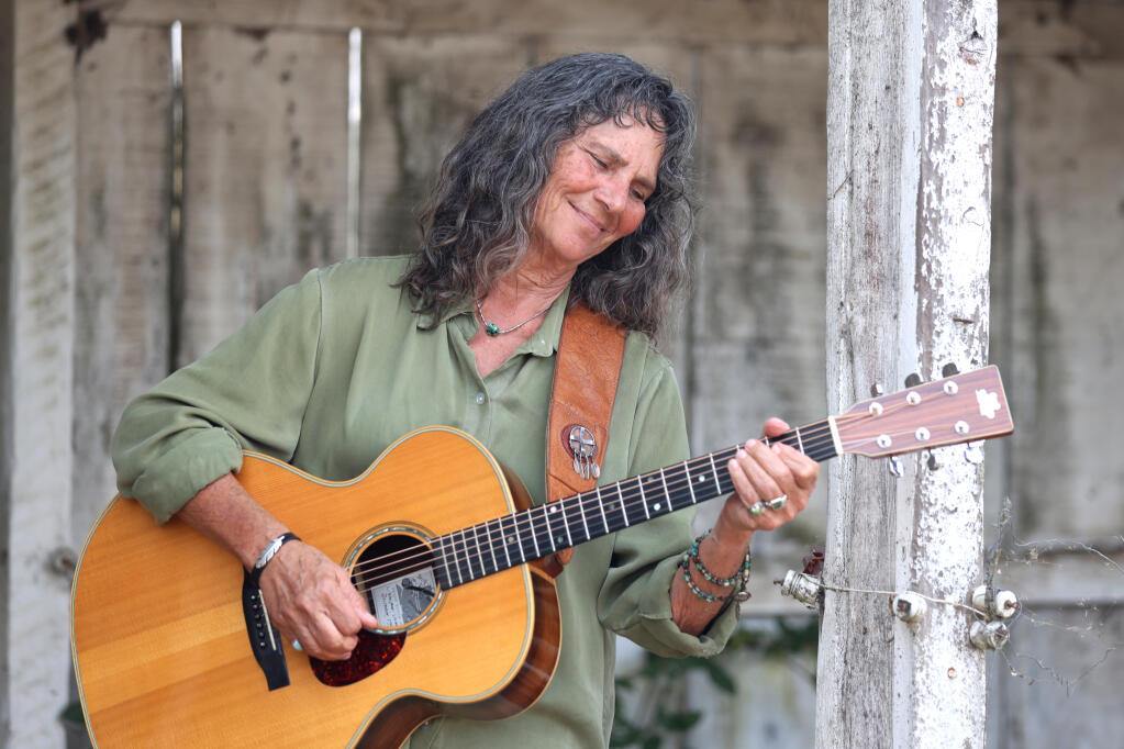 Musician Nina Gerber plays her guitar at her home in Sebastopol, Calif., on Monday, Aug. 29, 2022. (Beth Schlanker / The Press Democrat)