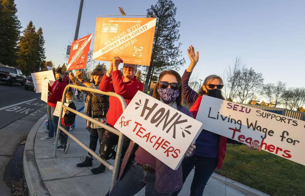 From left, Yvette Wilhelmsen, Tamara Norton, Amber Griffith and Linda Pease protested outside of the Cotati-Rohnert Park Unified School District board meeting at Rancho Cotate High School on Tuesday, February, 15, 2022. (Photo by John Burgess/The Press Democrat)
