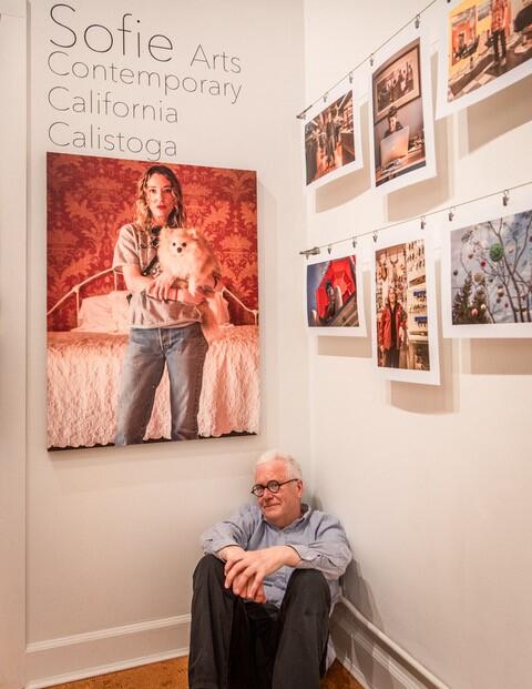 Photographer Clark James Mishler submits to posing in front of a camera at Sofie Contemporary Arts, where an exhibition of his portraits runs through July 26.  (Pat Hampton / Calistoga Tribune)