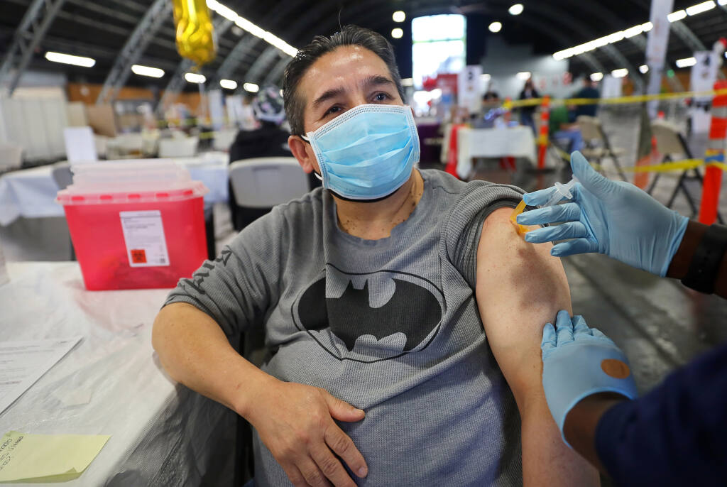 Restaurant cook Vincente Pineda receives a dose of the Moderna COVID-19 vaccine at the Santa Rosa Community Health vaccination clinic, at the Sonoma County Fairgrounds, in Santa Rosa on Monday, Feb. 22, 2021.  (Christopher Chung/ The Press Democrat)