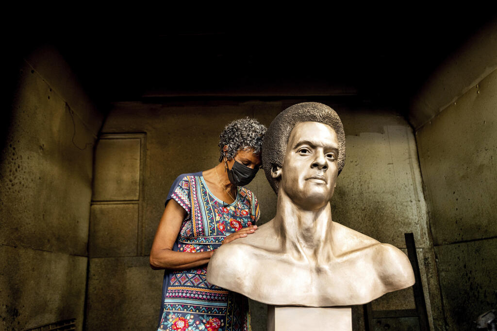 Fredrika Newton, widow of Black Panther Party co-founder Huey Newton, touches a bust of her late husband at Artworks Foundry on Tuesday, Aug. 10, 2021, in Berkeley, Calif. The bust is scheduled to be unveiled in Oakland on Sunday, Oct. 24, the first permanent public art piece honoring the party in the city of its founding.  (AP Photo/Noah Berger)