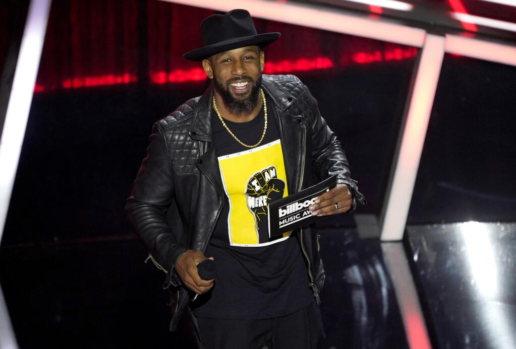 FILE - Stephen "tWitch" Boss presents the award for top Latin artist at the Billboard Music Awards in Los Angeles on Oct. 14, 2020. (AP Photo/Chris Pizzello, File)