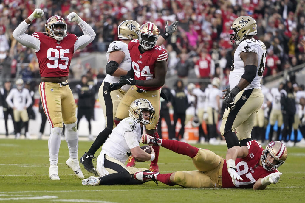 San Francisco 49ers defensive end Drake Jackson (95) reacts after defensive end Nick Bosa, bottom right, sacked New Orleans Saints quarterback Andy Dalton, bottom middle, during the second half of an NFL football game in Santa Clara, Calif., Sunday, Nov. 27, 2022. (AP Photo/Godofredo A. Vásquez)
