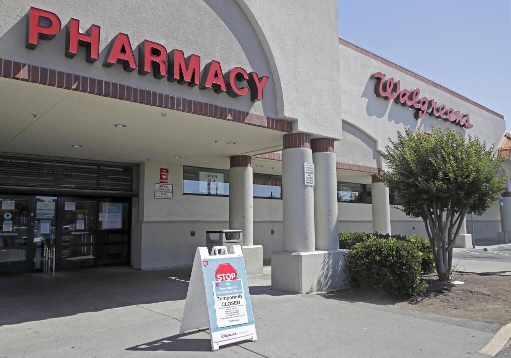FILE - In this June 3, 2020, file photo, a sign alerts customers to a closed Walgreens pharmacy store following an overnight shooting in Vallejo, Calif.  (AP Photo/Ben Margot, File)