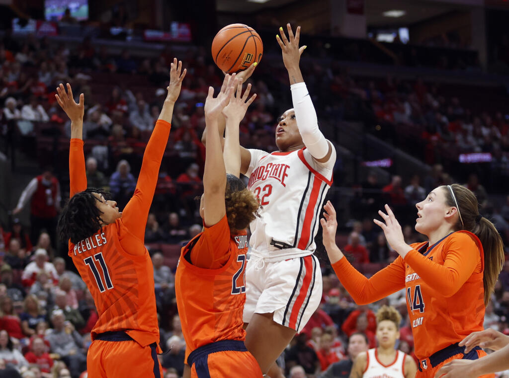 Ohio State forward Cotie McMahon (32) shoots between Illinois guard Jada Peebles (11), forward Brynn Shoup-Hill (23) and forward Kendall Bostic (44) during the second half of an NCAA college basketball game in Columbus, Ohio, Sunday, Jan. 8, 2023. (AP Photo/Paul Vernon)