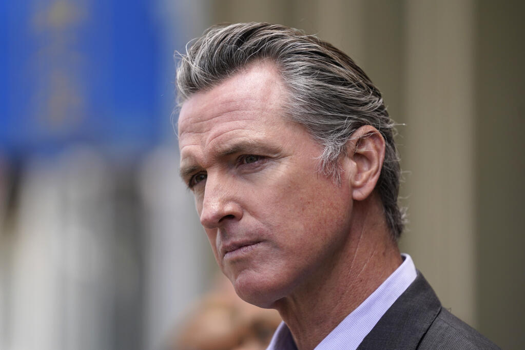 FILE - In this June 3, 2021 file photo, California Gov. Gavin Newsom listens to questions during a news conference outside a restaurant in San Francisco. Six weeks after California officials announced that Newsom would face an almost certain recall election, the contest remains framed by uncertainty even the date when it might take place is unclear. (AP Photo/Eric Risberg,File)