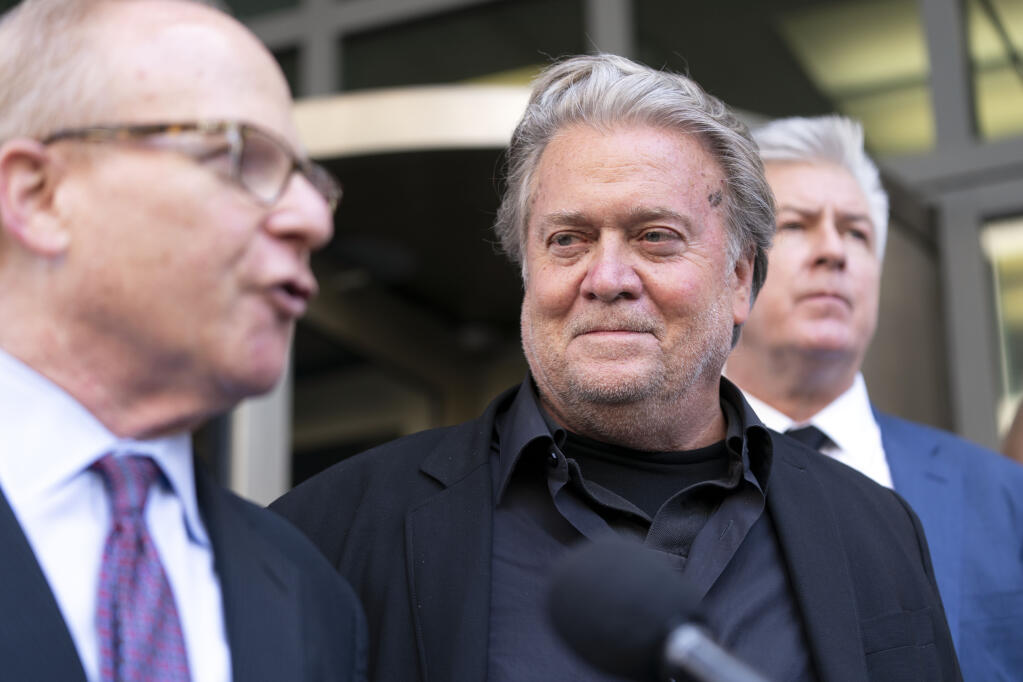 Former White House strategist Steve Bannon, accompanied by his attorneys David Schoen, left and M. Evan Corcoran, right, speaks with the media  departs federal court, Friday, July 22, 2022, in Washington. Bannon, a longtime ally of former President Donald Trump has been convicted of contempt charges for defying a congressional subpoena from the House committee investigating the Jan. 6 insurrection at the U.S. Capitol.  (AP Photo/Jose Luis Magana)