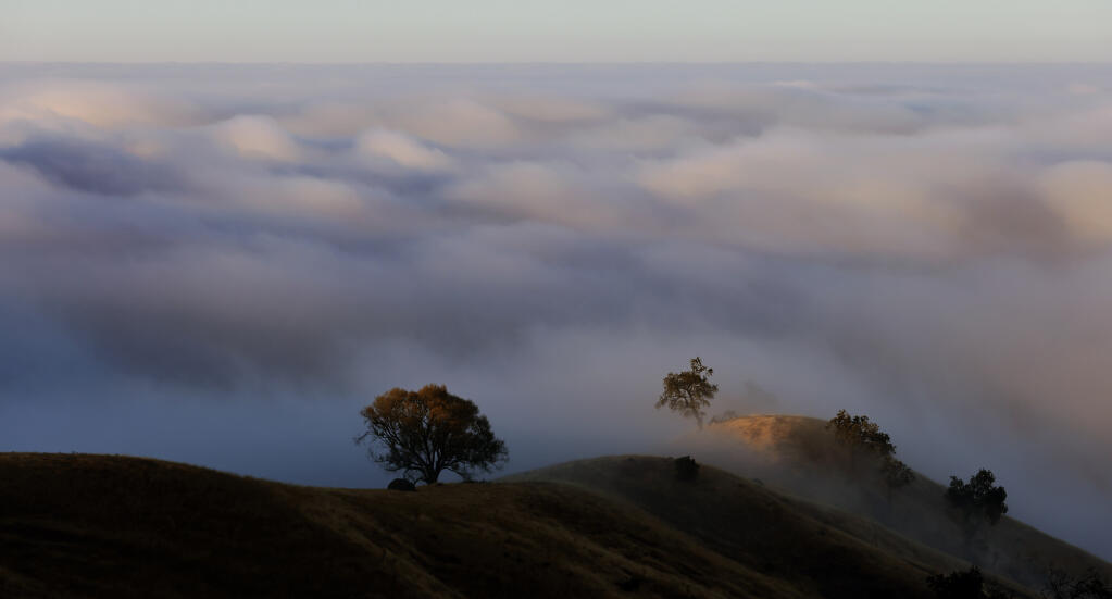 The inland protrusion of the marine stratus layer pancakes up against the Mayacamas Mountains, Sunday, Aug. 6, 2022 ,above the Alexander Valley. (Kent Porter/The Press Democrat file)