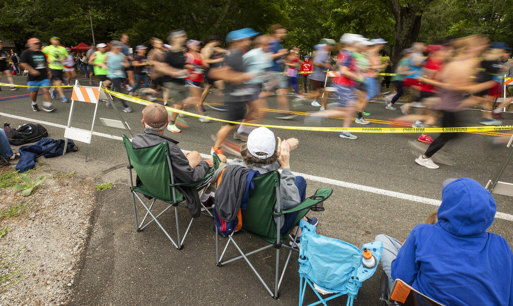 After a two-year COVID-induced hiatus, fans clap for runners at the start of the Kenwood 10K Footrace on the Fourth of July, 2022. (John Burgess / The Press Democrat)
