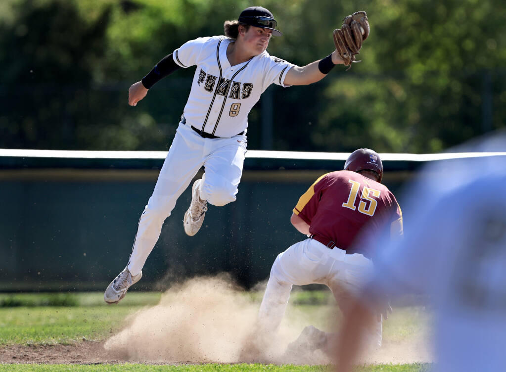 Maria Carrillo third baseman Tommy McPheesnags a wide throw above safely sliding Cardinal Neman baserunner Nate  Phelps, during a three run first inning win over Newman's win over the Puma's, Wednesday, April 6, 2022 at Maria Carrillo High School in Santa Rosa.   (Kent Porter / The Press Democrat) 2022