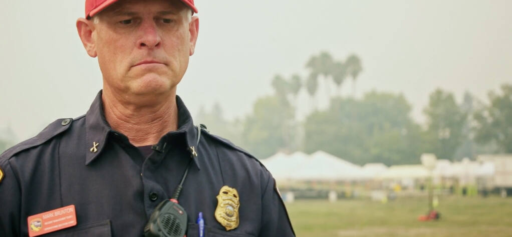 In this screenshot from an episode of “Cal Fire,” Cal Fire Battalion Chief Mark Brunton describes what it was like to tell family members that their home was destroyed in the Glass fire. (Cal Fire / Discovery Channel)