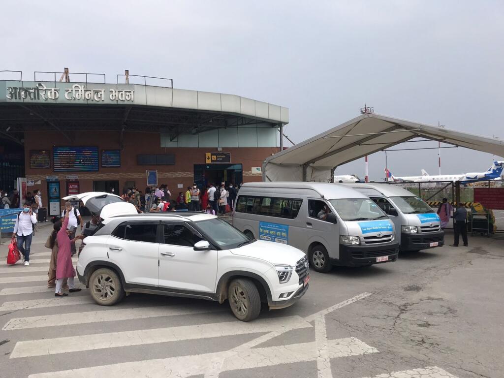 People walk outside the Tribhuvan International Airport in Kathmandu, Nepal, Sunday, May 29, 2022. A small airplane with 22 people on board flying on a popular tourist route was missing in Nepal’s mountains on Sunday, an official said. The Tara Airlines plane, which was on a 15-minute scheduled flight to the mountain town of Jomsom, took off from the resort town of Pokhara, 200 kilometers (125 miles) east of Kathmandu. It lost contact with the airport tower shortly after takeoff. (AP Photo/Niranjan Shreshta)