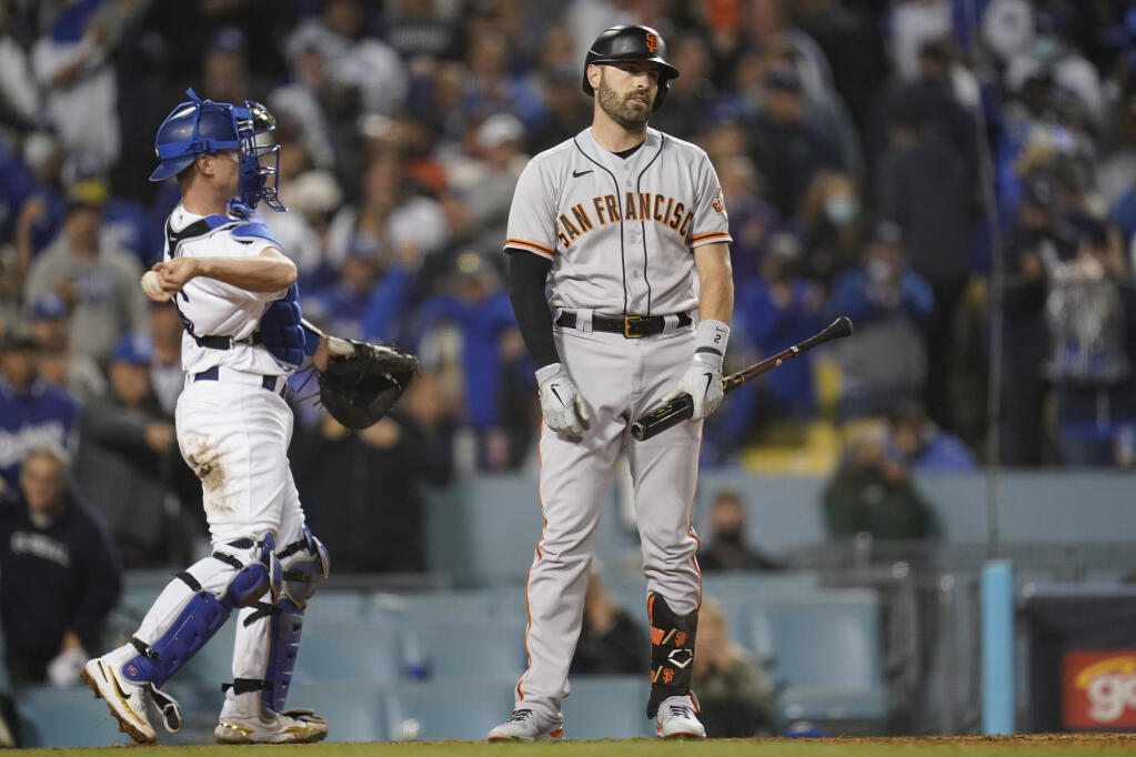 The San Francisco Giants’ Curt Casali reacts after he was called out on strikes to end the top of the eighth inning in Game 4 of the National League Division Series against the Los Angeles Dodgers, Tuesday, Oct. 12, 2021, in Los Angeles. The Dodgers won 7-2. (AP Photo/Ashley Landis)