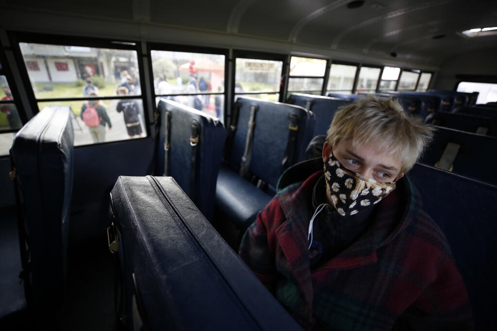 Laguna High School student Eddie Agnew, 16, waits on the bus outside El Molino High School in Forestville, California on Monday, April 12, 2021 before it heads to his school in Sebastopol, California. (Beth Schlanker/ The Press Democrat)