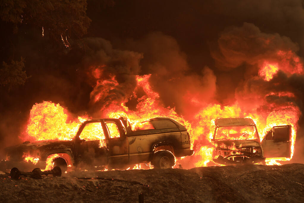 A home, background, and cars catch fire along Highway 101 north of Willits, Monday, Sept. 7, 2020 as the Oak fire burns nearly 1,000 acres. (Kent Porter / The Press Democrat) 2020
