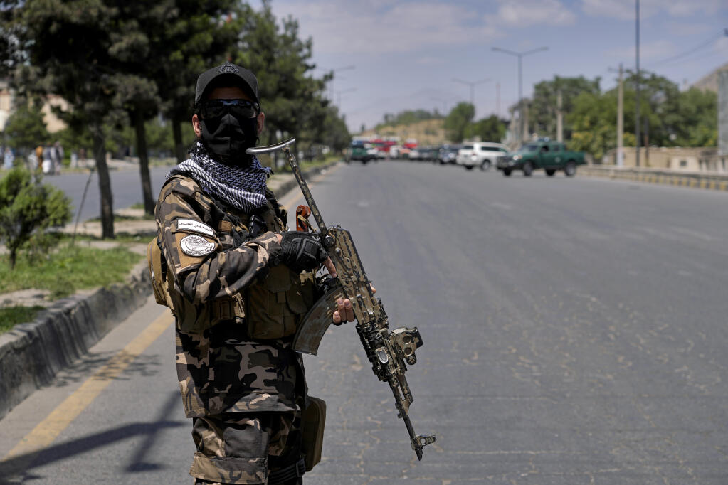 A Taliban fighter stands guard at the site of an explosion in Kabul, Afghanistan, Saturday, June 18, 2022. (AP Photo/Ebrahim Noroozi)