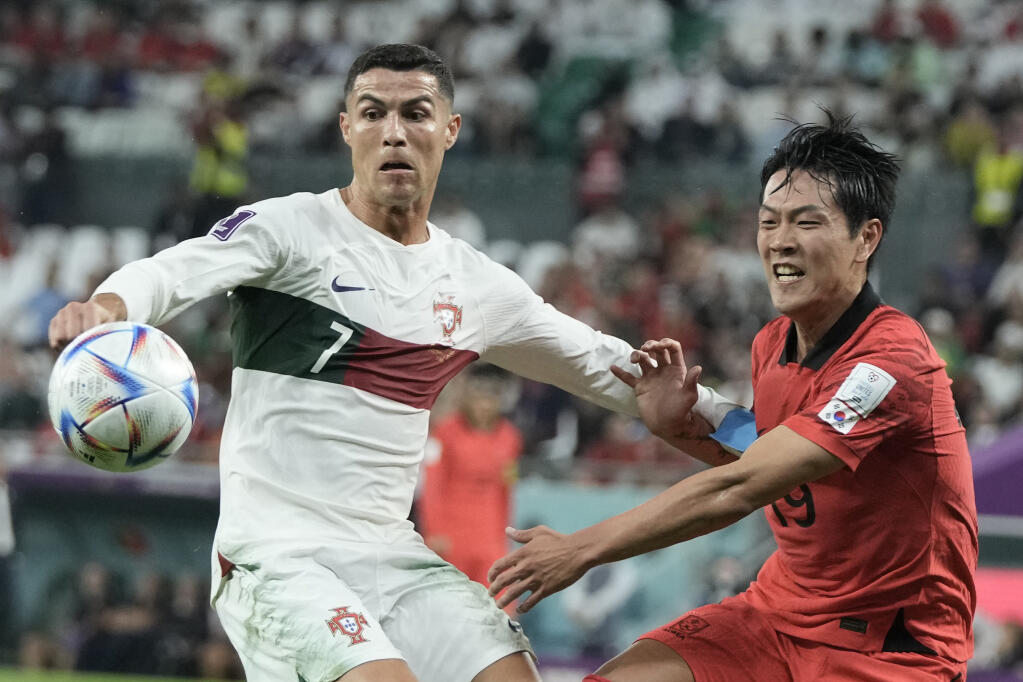 Portugal’s Cristiano Ronaldo, left and South Korea’s Kim Young-gwon vie for the ball during Friday’s World Cup game in Al Rayyan, Qatar. (Hassan Ammar / ASSOCIATED PRESS)