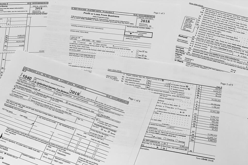 Copies of former President Donald Trump and former first lady Melania Trump individual tax returns for 2018, released by the Democratic-controlled House Ways and Means Committee, are photographed Friday, Dec. 30, 2022. The returns, which include redactions of some personal sensitive information such as Social Security and bank account numbers, span nearly 6,000 pages, including more than 2,700 pages of individual returns, and more than 3,000 pages in returns for Trump's business entities. (AP Photo/Jon Elswick)