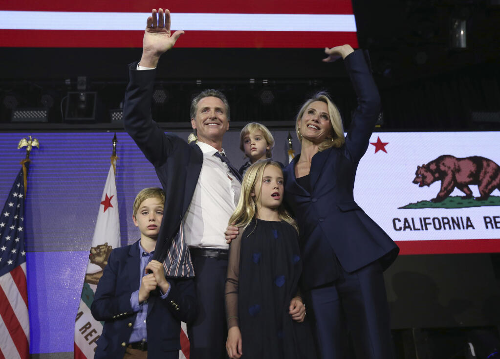 FILE - In this Nov. 6, 2018, file photo, then Lt. Gavin Newsom, a Democrat, holds his son, Dutch, 2, as he waves to the crowd at an election night party in Los Angeles after being elected California's 40th. Newsom was accompanied by his wife, Jennifer Siebel Newsom, and their children. Newsom is facing the second recall of a governor in California history, and the last day to vote is Sept. 14, 2021.(AP Photo/Rich Pedroncelli, File)