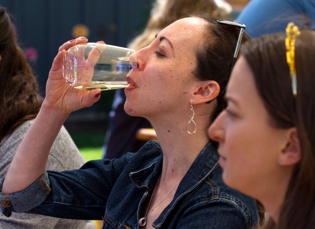 Sarah Pomarico, of South San Francisco, Calif., tastes wine with friends, during the “Wine for a Cause Flight” event to benefit Redwood Empire Food Bank, held at Hook & Ladder Winery in Santa Rosa, Calif., on Saturday, May 22, 2021. (Photo by Darryl Bush / For The Press Democrat)