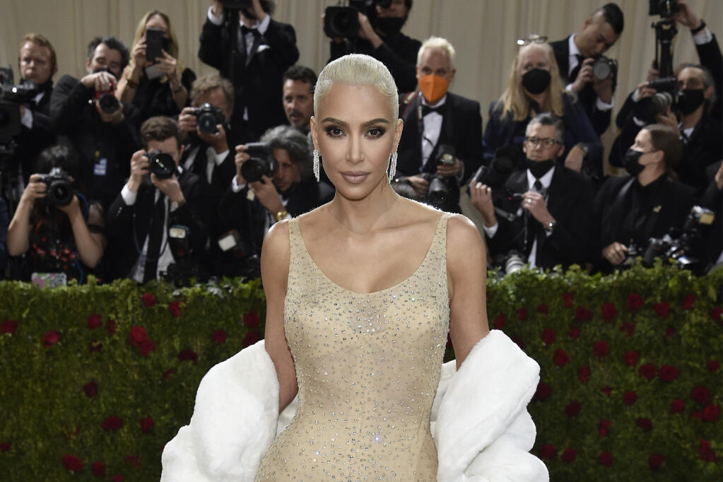 FILE - Kim Kardashian attends The Metropolitan Museum of Art's Costume Institute benefit gala celebrating the opening of the "In America: An Anthology of Fashion" exhibition on Monday, May 2, 2022, in New York. Reality tv star and entrepreneur Kim Kardashian has agreed to settle charges brought by the Securities and Exchange Commission and pay $1.26 million because she promoted on social media a crypto asset security offered and sold by EthereumMax without disclosing the payment she received for the plug. The SEC said Monday, Oct. 3, 2022, that Kardashian has agreed to cooperate with its ongoing investigation.(Photo by Evan Agostini/Invision/AP, File)