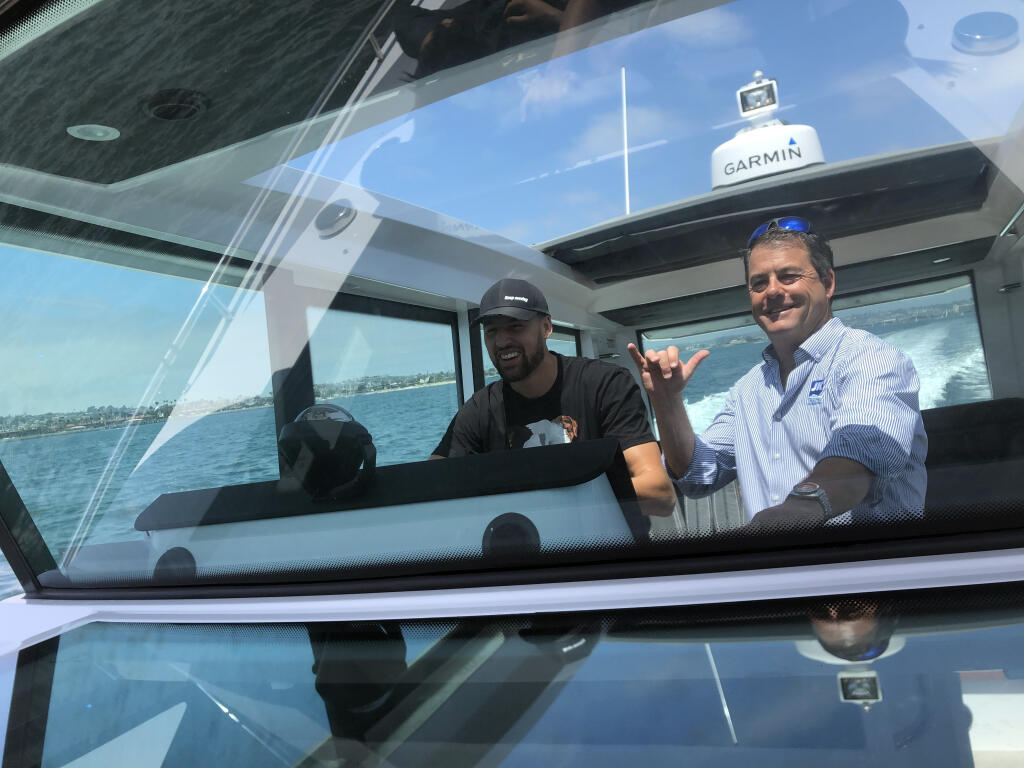 A photo provided by Anthony Nuccio shows Klay Thompson, left, and his boat dealer, Kenyon Martin, on his test drive. Injury woes sent the Warriors guard looking for solace. He found it on the water. (Anthony Nuccio)