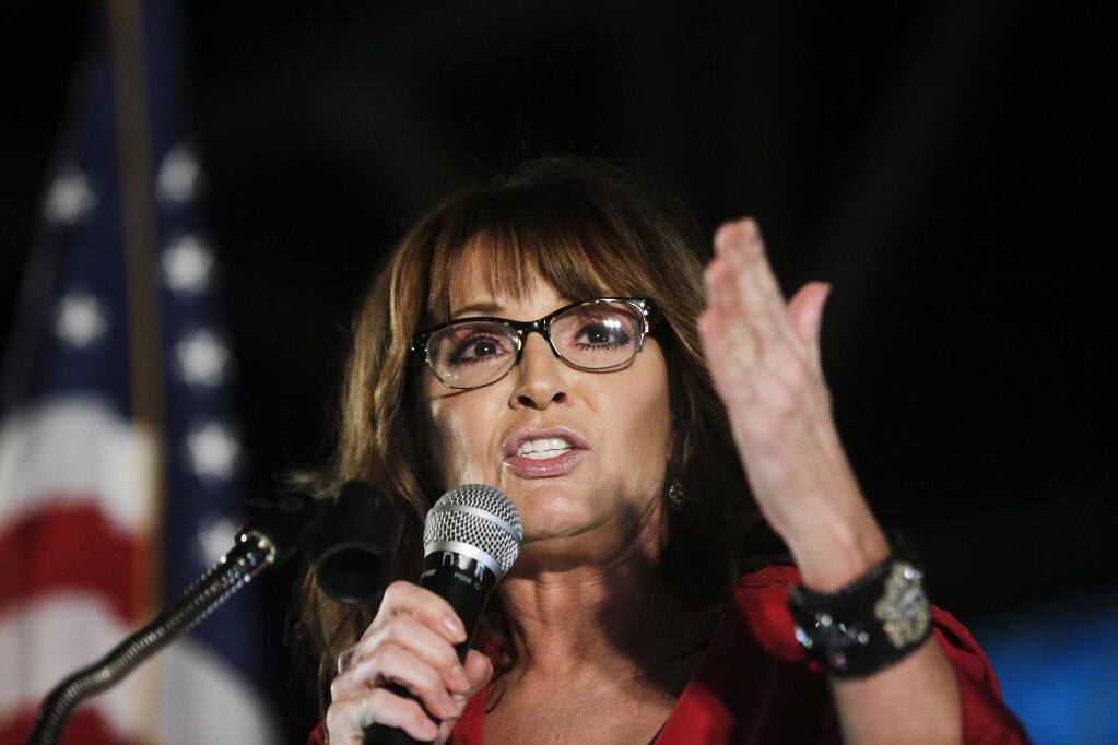 FILE - In this Sept. 21, 2017, file photo, former vice presidential candidate Sarah Palin speaks at a rally in Montgomery, Ala. Palin says she tested positive for COVID-19 and is urging people to take steps to guard against the coronavirus, including wearing masks in public. (AP Photo/Brynn Anderson, File)