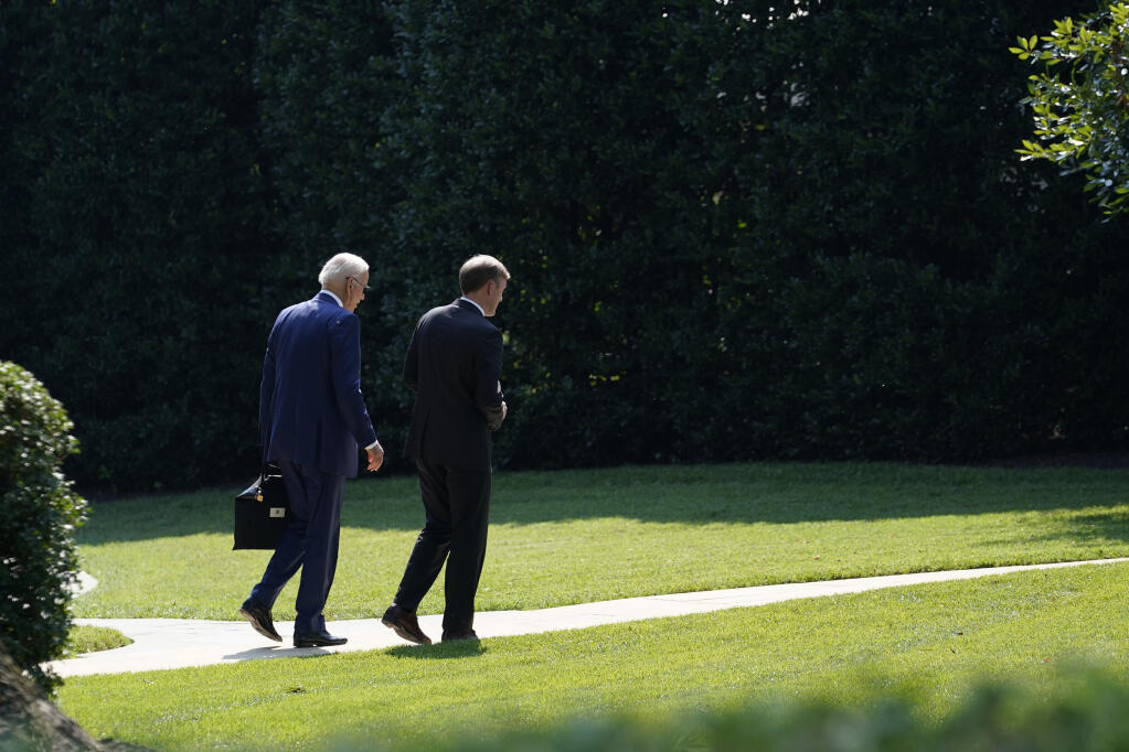 President Joe Biden, left, walks back to the Oval Office with National Security Adviser Jake Sullivan, right, at the White House in Washington, Tuesday, July 27, 2021. They were returning from a visit to the Office of the Director of National Intelligence in McLean, Virginia. (AP Photo/Susan Walsh)