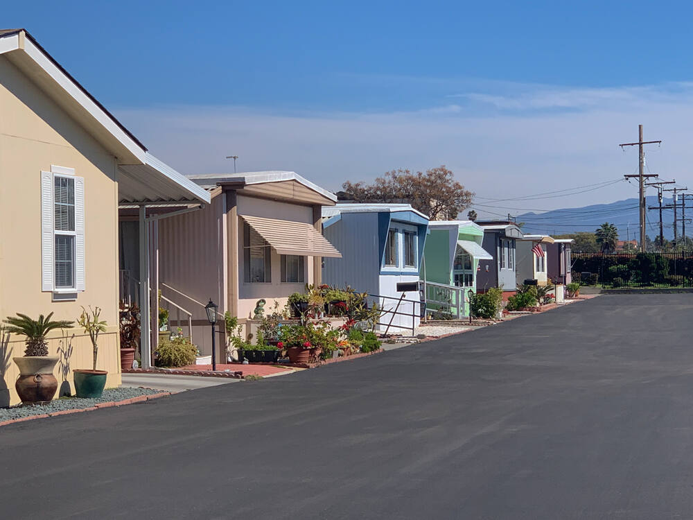 View of row of mobile homes in trailer park.