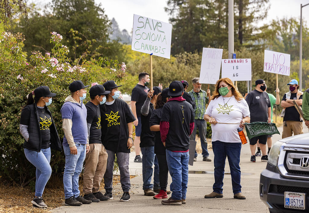 About 80 people, mostly employees of Elyon Cannabis, protest regulations governing marijuana farms outside city limits in front of the Sonoma County Board of Supervisors chamber on Friday, Sept. 10, 2021. (John Burgess / The Press Democrat)