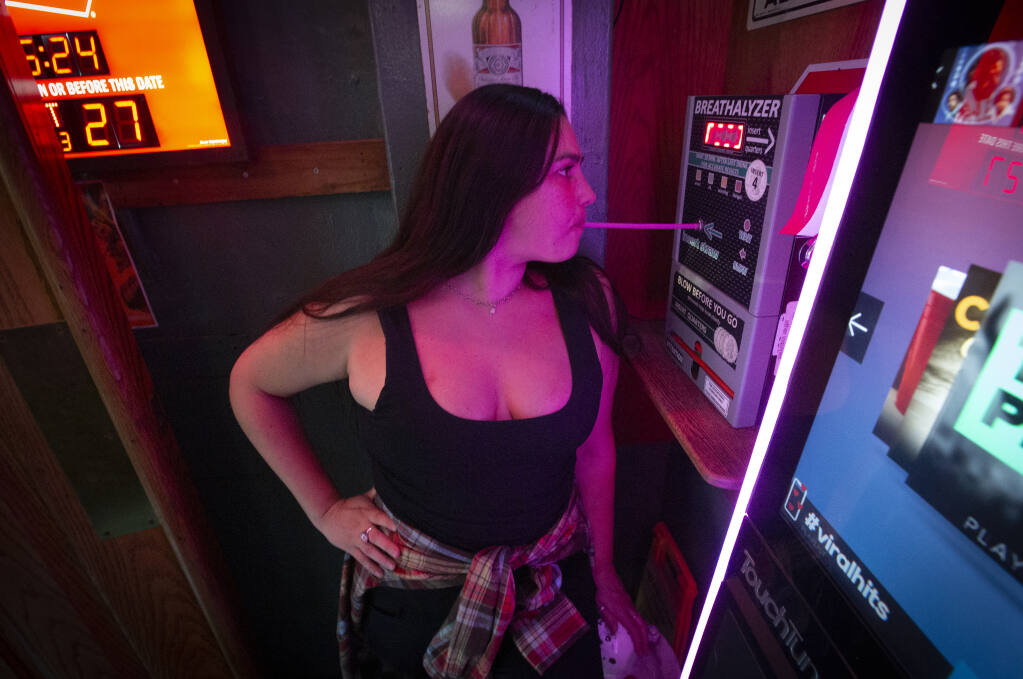 Jasmine Ramirez tests her level of sobriety with the breathalyzer at the Town Square on First Street East on Tuesday, Sept. 27, 2022. (Robbi Pengelly/Index-Tribune)