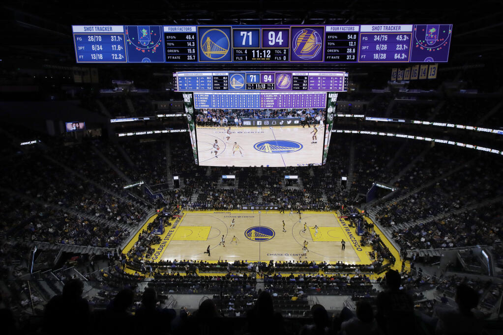 FILE - In this Oct. 5, 2019, file photo, fans watch from a general view of Chase Center during the second half of a preseason NBA basketball game between the Golden State Warriors and the Los Angeles Lakers in San Francisco. Professional hockey and basketball teams are raring to bring back fans into indoor arenas now that California has authorized the return of live performances later in April, but theaters and music venues appear to be more cautious given capacity and safety concerns. The Golden State Warriors in San Francisco and Los Angeles Lakers said on social media that they are working with local health officials to welcome fans, but could not provide more details. (AP Photo/Jeff Chiu, File)