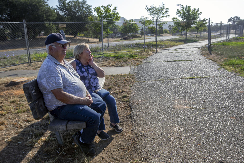 Henry and Paula Manjarrez sit for a moment during their morning walk on the path that circles the playing fields at Maxwell Farms Regional Park on Monday, August 15, 2022.  (Robbi Pengelly/Index-Tribune)