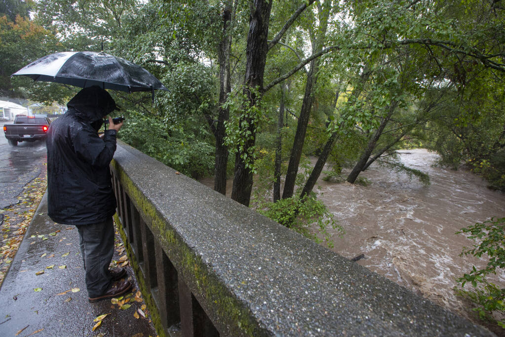 While the amount of rain that fell last weekend might bring some relief to the perennial anxiety over fire season, officials say that the worst-case scenario is always possible. The creek at the Glen Ellen bridge swelled with swift -moving water on Sunday, Oct. 24, 2021, as some businesses closed for the day due to weather conditions. (Photo by Robbi Pengelly/Index-Tribune)