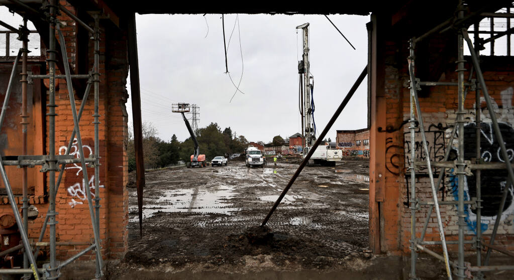 After decades of planning, the Cannery project is moving forward, anchoring historic Railroad Square in Santa Rosa. Crews, Thursday, Dec. 29, 2022, bore deep holes into the earth to fill the space with concrete, adding stability to the soil. (Kent Porter/The Press Democrat)