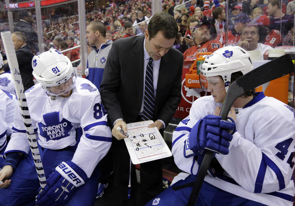 Toronto Maple Leafs assistant coach Scott Gordon shows a play to players in the third period against the Capitals Tuesday, Feb. 5, 2013 in Washington. The Maple Leafs won 3-2. (AP Photo/Alex Brandon)