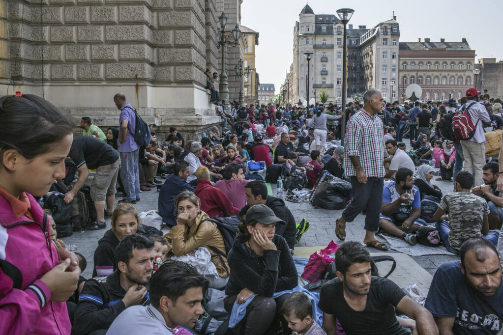 Hundreds of families wait outside a train station in Budapest, Hungary, during the migrant crisis on Sept. 2, 2015. Complacency, wishful thinking, political timidity, a unanimity rule and panic over migration have combined to make Hungary a major threat to the European Union. (Mauricio Lima/The New York Times)