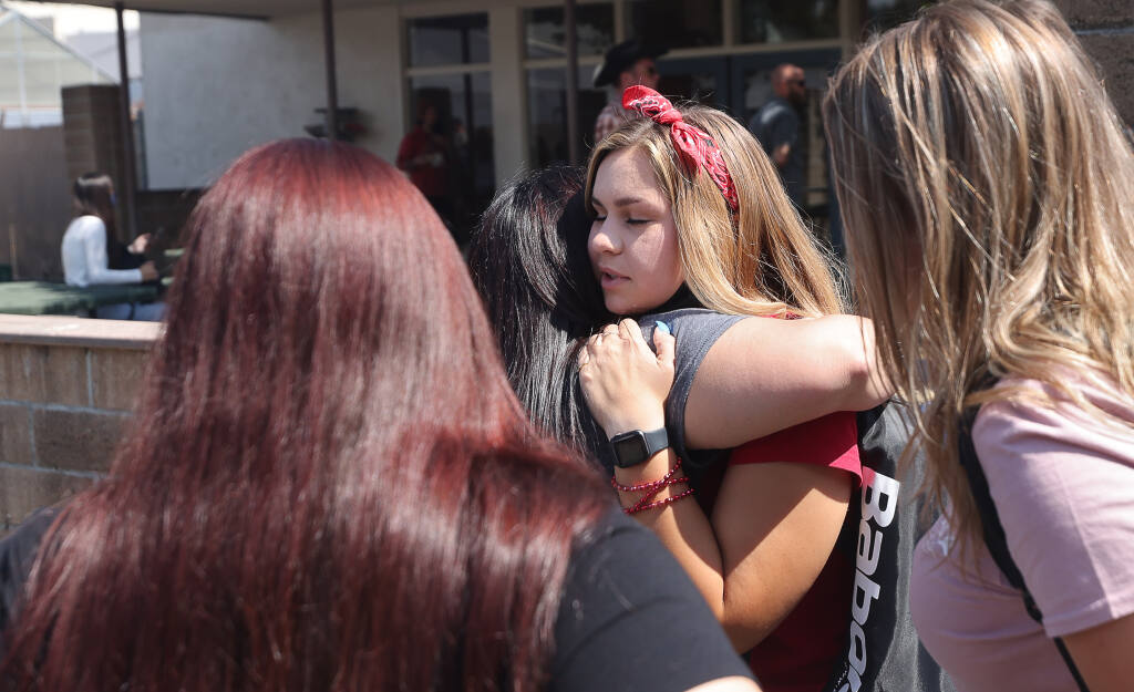 A West County High School student hugs her mother following a campus lockdown in Sebastopol on Thursday, Sept. 9, 2021.  (Christopher Chung / The Press Democrat)
