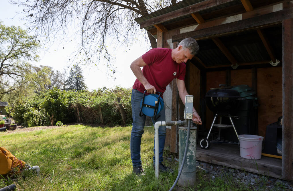 David Noren, a member of the Santa Rosa Plain Groundwater Sustainability Agency's advisory committee, uses a water level indicator to check the water level in the well on his property in Sebastopol on Thursday, April 7, 2022. (Christopher Chung/ The Press Democrat)