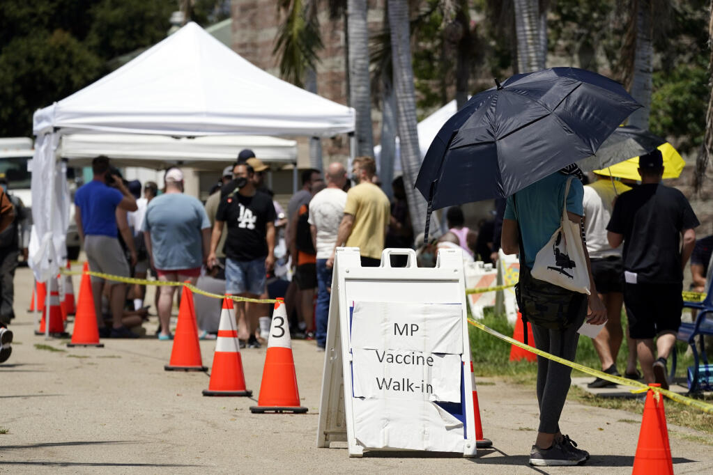 FILE - People line up at a monkeypox vaccination site on Thursday, July 28, 2022, in Encino, Calif. California's public health officer said they are pressing for more vaccine and closely monitoring the spread of the monkeypox virus. (AP Photo/Marcio Jose Sanchez, File)