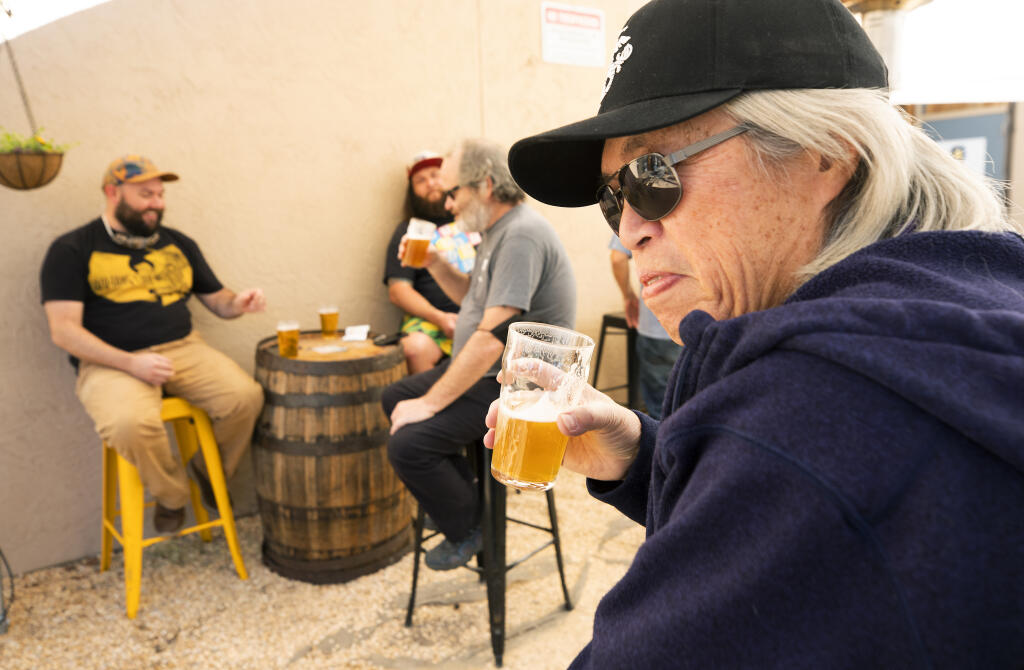 John Dang has a beer with friends at the Cooperage Brewing Co. in Santa Rosa on Friday, March 12, 2021. New state laws will allow breweries to serve beer without food beginning Saturday. (John Burgess / The Press Democrat)