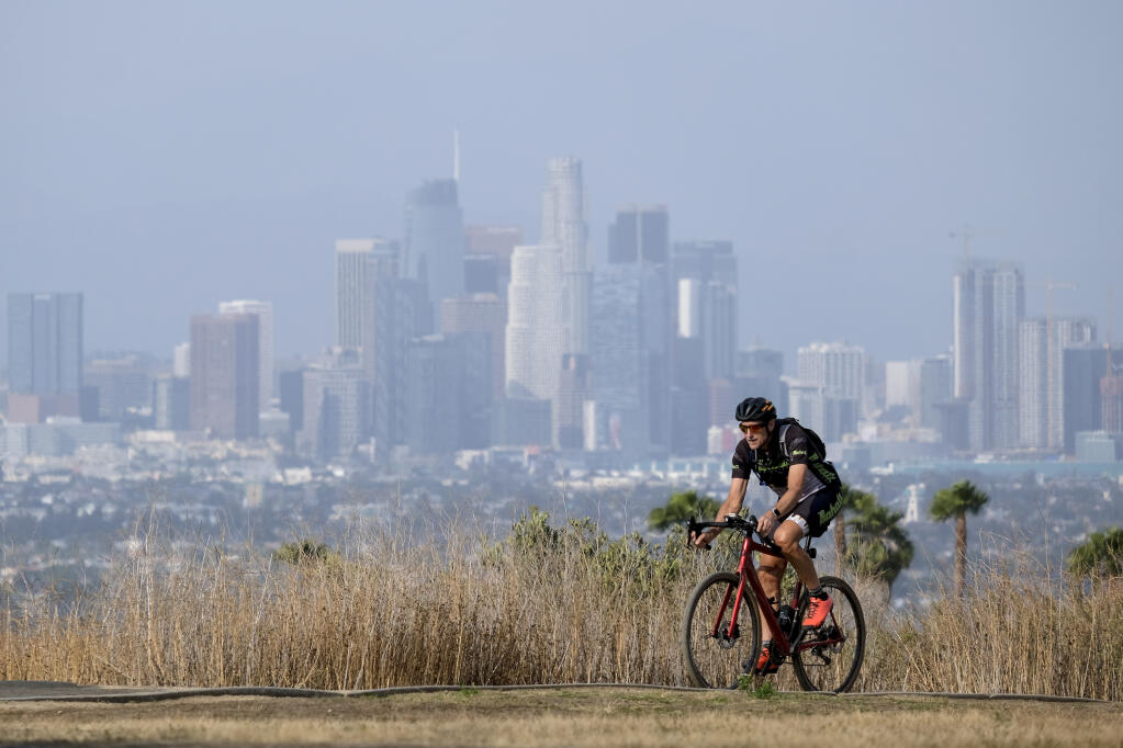 Steven Thorpe, 62, of Manhattan Beach, rides in the heat on Kenneth Hahn State Recreation Area Wednesday, June 16, 2021, in Los Angeles. (AP Photo/Ringo H.W. Chiu)